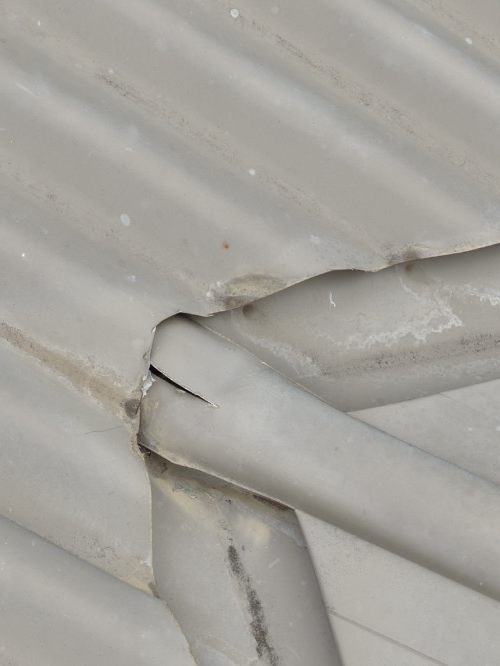 Storm damaged roof sheeting